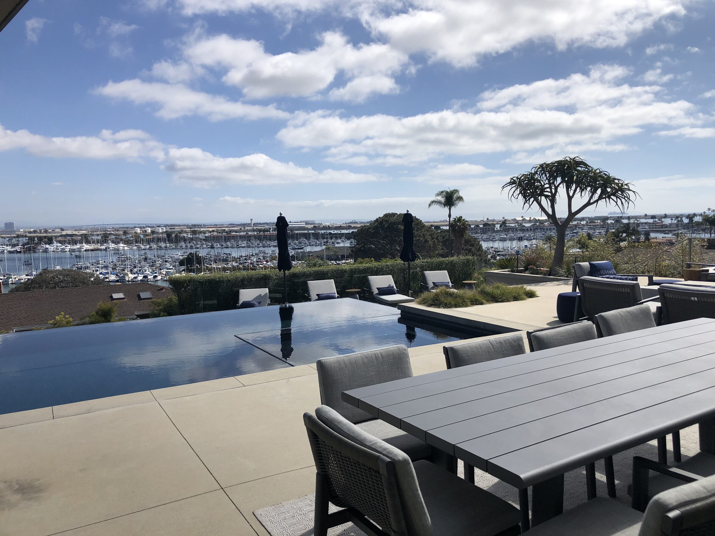 Infinity pool with panoramic marina and sky view