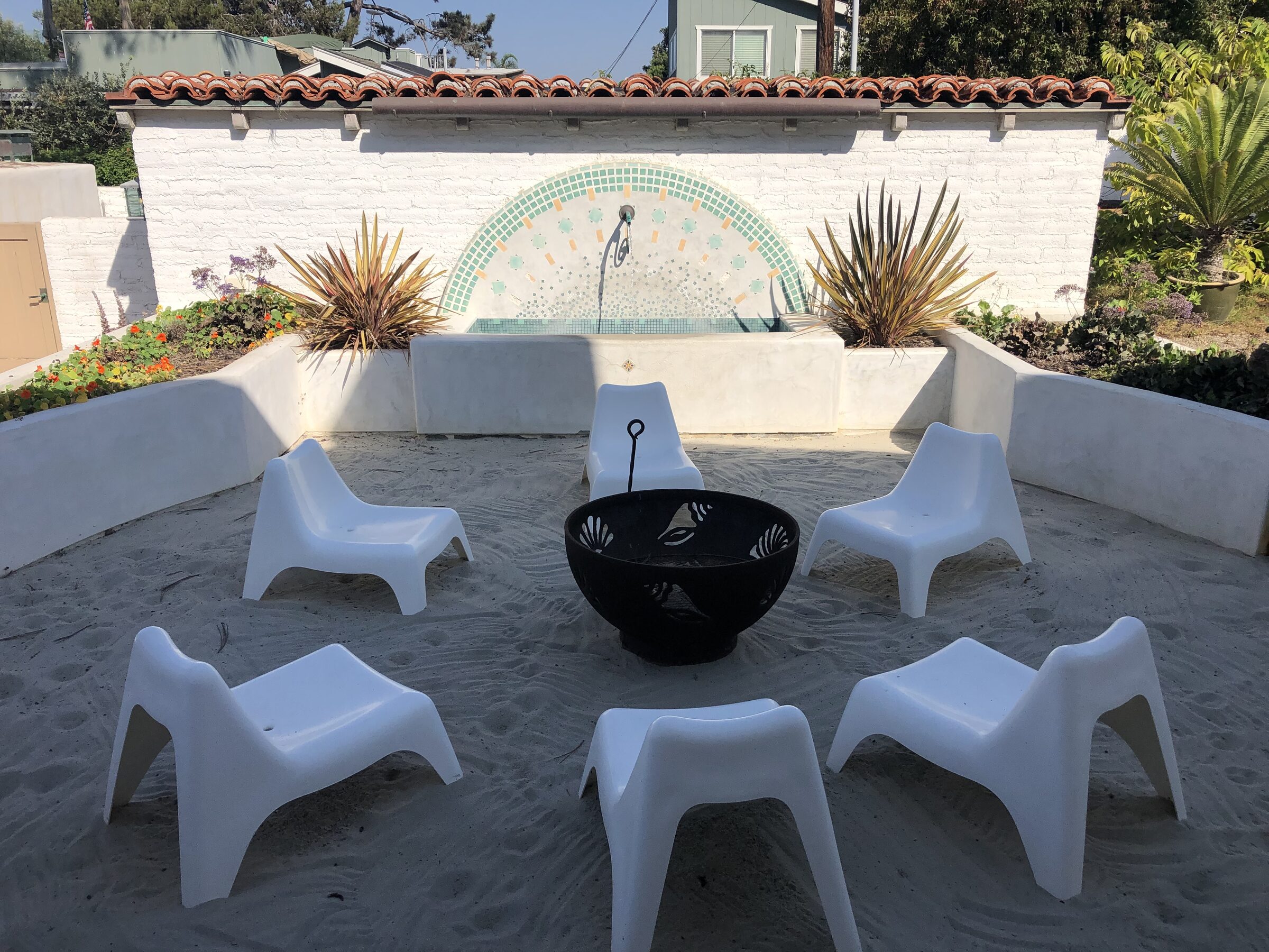Mexican Beach House courtyard with fire pit and mosaic fountain