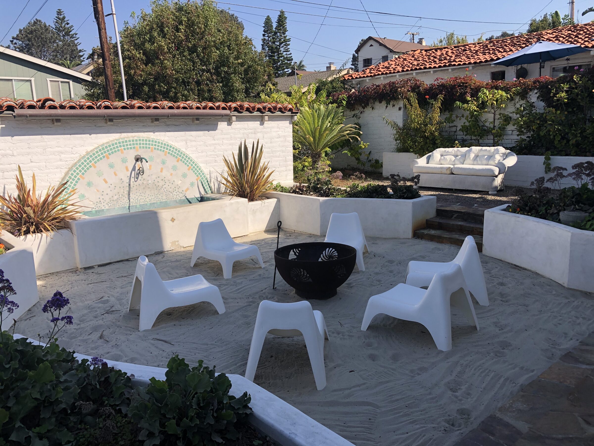 Wide courtyard lounge area with fire pit
