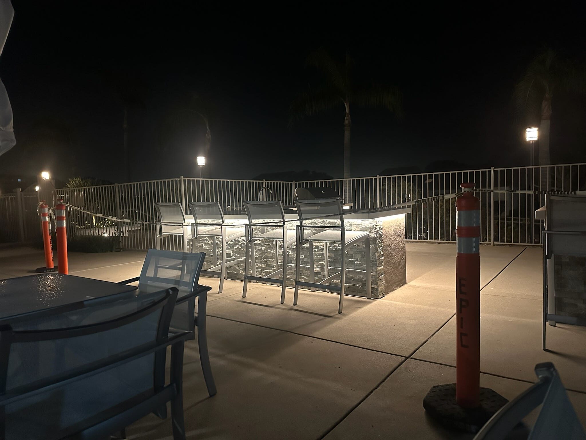 Outdoor kitchen bar seating at night