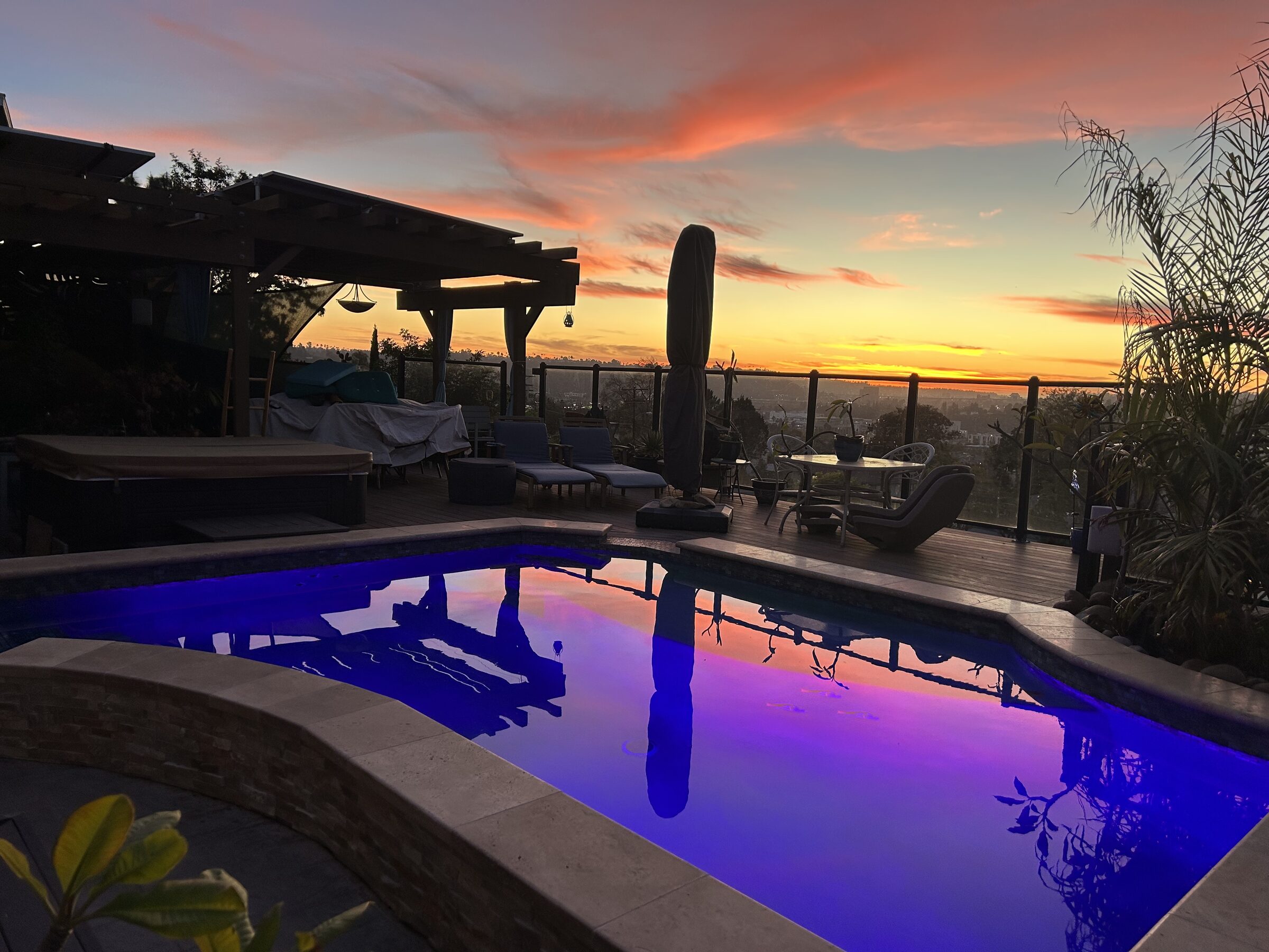 Pool with LED lighting at sunset under pergola