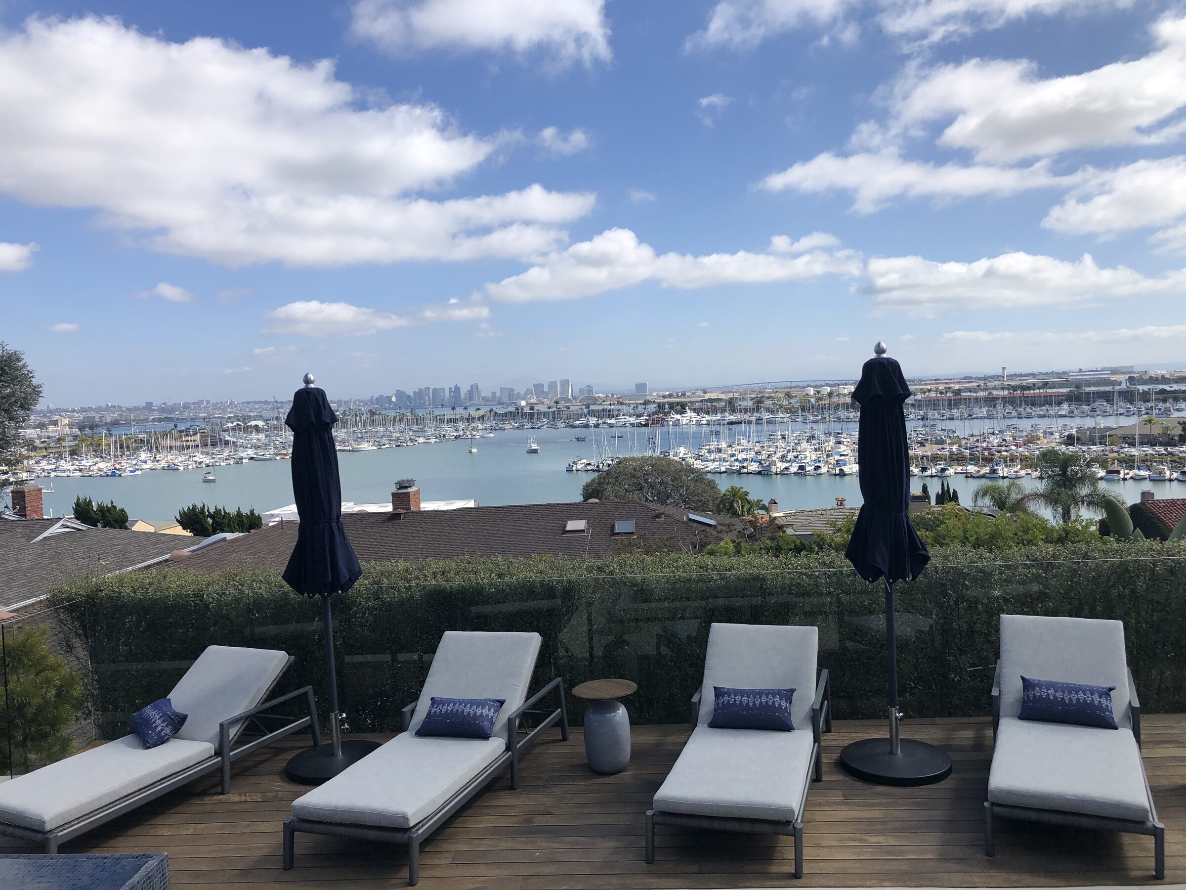 Rooftop deck with loungers and harbor panorama