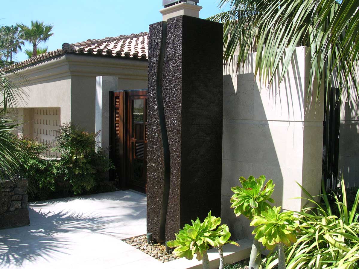 Entry gate with carved stone pilaster