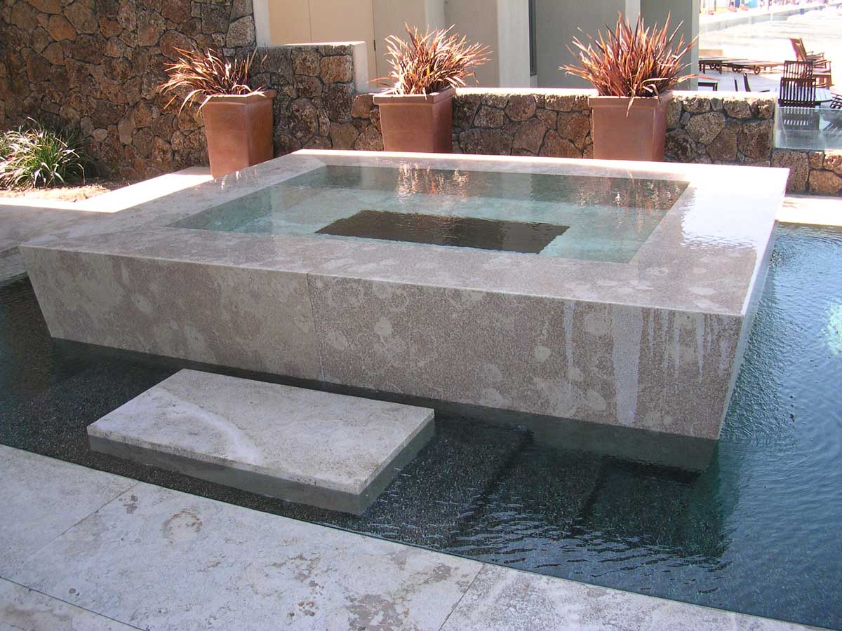 Raised stone spa with water feature