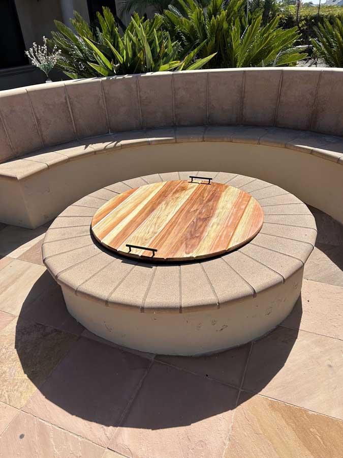 Round fire pit on flagstone patio