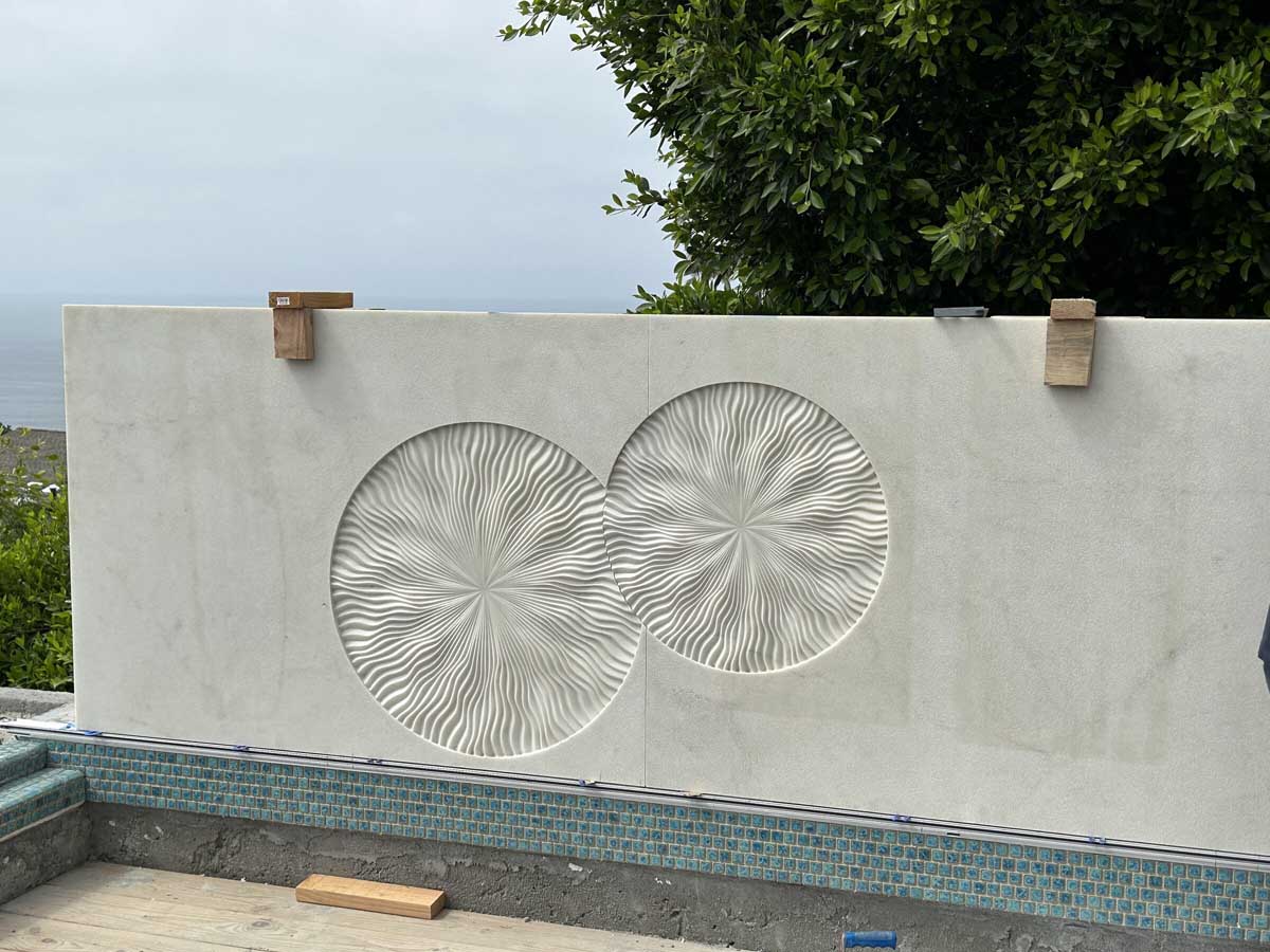 Pool wall with carved sunburst medallions
